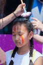 ALMATY, KAZAKHSTAN - JUNE 10, 2018: Unidentified girl makeup artist makes a bright carnival face painting to the