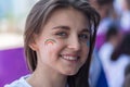 ALMATY, KAZAKHSTAN - JUNE 10, 2018: Unidentified girl makeup artist makes a bright carnival face painting to the