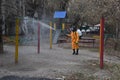 Almaty / Kazakhstan - 03.26.2020 : a man in a special suit disinfects the yard and Playground