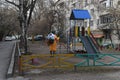 Almaty / Kazakhstan - 03.26.2020 : a man in a special suit disinfects the yard and Playground