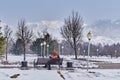 Park of first president of republic, Almaty, Kazakhstan. Winter landscape.Tourist resting on bench