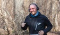 ALMATY, KAZAKHSTAN - March 16, 2019: portrait of a handsome mature unidentified man who runs through the woods during