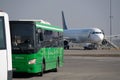 Almaty / Kazakhstan - 03.27.2020 : passenger bus on the background of the arriving plane