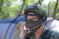 Almaty, Kazakhstan - 06.29.2013 : A player in airsoft gear is talking on a mobile phone