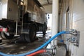 Almaty, Kazakhstan - 08.09.2016 : Pouring milk into the milk truck through hoses at the factory