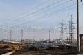 Almaty, Kazakhstan - 02.04.2021 : Power lines on the background of a large layer of smog covering the city and mountains Royalty Free Stock Photo