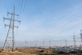 Almaty, Kazakhstan - 02.04.2021 : Power lines on the background of a large layer of smog covering the city and mountains Royalty Free Stock Photo