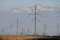 Almaty, Kazakhstan - 02.04.2021 : Power lines on the background of a large layer of smog covering the city and mountains Royalty Free Stock Photo