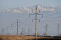 Almaty, Kazakhstan - 02.04.2021 : Power lines on the background of a large layer of smog covering the city and mountains Royalty Free Stock Photo