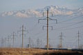 Almaty, Kazakhstan - 02.04.2021 : Power lines on the background of a large layer of smog covering the city and mountains Royalty Free Stock Photo