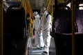 Almaty / Kazakhstan - 03.18.2020 : two men in a special suit disinfect the bus Royalty Free Stock Photo