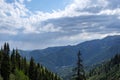 Almaty mountains with cloudy stormy clouds. Overcast - weather storm. Royalty Free Stock Photo