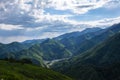 Panoramic landscape of Almaty mountains with cloudy stormy clouds.
