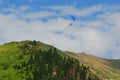 Almaty mountains with paraplane flying in the sky