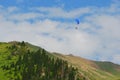 Almaty mountains with paraplane flying in the sky