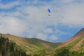 Almaty mountains with paraplane flying in the sky