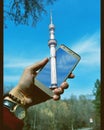 Almaty tower in my hand. The Almaty Television Tower, or simply Almaty Tower, is a 371.5-meter-high 1,219 ft steel television