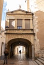 Picturesque street that passes under an arch located in the historic center of