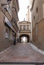 Picturesque street that passes under an arch located in the historic center of