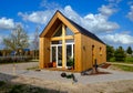 Outside view of a wooden tiny house on a beautiful day