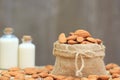 Almond in bag with almonds milk in glass bottle on the table