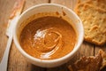 Almond butter in bowl with crackers on wooden table Royalty Free Stock Photo