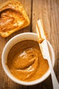 Almond butter in bowl with crackers on wooden table Royalty Free Stock Photo