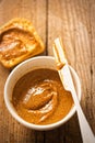 Almond butter in bowl with crackers on wooden table Royalty Free Stock Photo