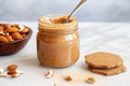 almond butter jar with a toast piece dipped in