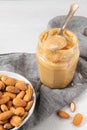 Almond butter, raw food paste made from grinding almonds into nut butter, crunchy and stir, white wooden table, copy space Royalty Free Stock Photo
