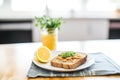 almond butter toast breakfast with orange juice and a cloth napkin
