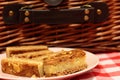 Almond cake slices on a plate with a picnic basket Royalty Free Stock Photo