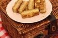 Almond cake slices on a plate with a picnic basket Royalty Free Stock Photo