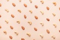 Almond, cashew on brown background flat lay pattern Royalty Free Stock Photo