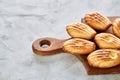 Almond cookies and raw almonds on wooden cutting board over white background, close-up, selective focus. Royalty Free Stock Photo