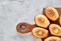 Almond cookies and raw almonds on wooden cutting board over white background, close-up, selective focus. Royalty Free Stock Photo