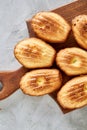 Almond cookies and raw almonds on wooden cutting board over white background, close-up, selective focus. Royalty Free Stock Photo