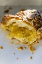 Almond croissant half in white paper box, macro