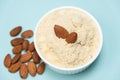 Almond flour and almonds on a light blue background Royalty Free Stock Photo