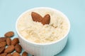 Almond flour and almonds on a light blue background Royalty Free Stock Photo