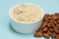 Almond flour and almonds on a light blue background Royalty Free Stock Photo