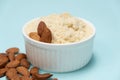 Almond flour and almonds on a light blue background Royalty Free Stock Photo