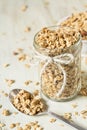 Almond Granola In Glass Jar With Spilled