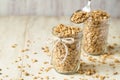 Almond Granola In Glass Jar With Spoon Scooping