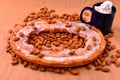 Almond Flavored Kringle on a bed of nuts with hot chocolate