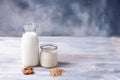 Almond milk bottle and jar of oat milk with almonds and oatmeal on a white wooden background Royalty Free Stock Photo