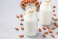 Almond milk in bottles with almonds on background, horizontal, copy space Royalty Free Stock Photo