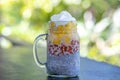 Almond milk chia pudding with fresh yellow mango and red goji berries in a glass jar mug. Vegan raw breakfast. Chia seeds and Royalty Free Stock Photo