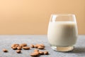 Almond milk in glass and almonds nuts around. Space for text. Healthy vegan milk replacer. Lack of cholesterol Royalty Free Stock Photo