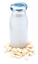 Almond milk in glass bottle. Includes peeled almonds. Royalty Free Stock Photo